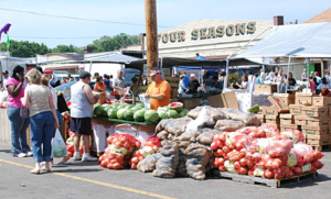 Produce vendors at the Four Seasons Flea & Farmers Market.