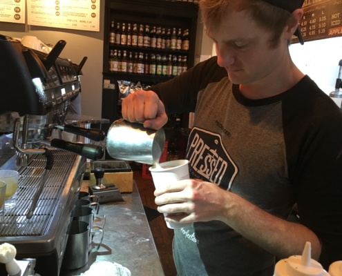 Barista making coffee at Pressed Coffee Bar & Eatery.