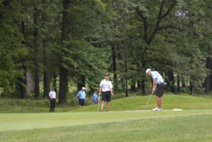 Golfers walk the Mill Creek Golf Course.
